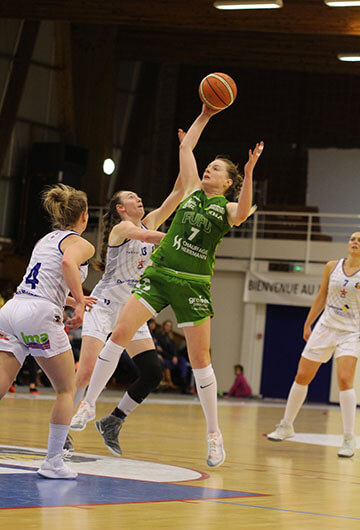 basketball player Karla is shooting in green jersey against player in white jersey