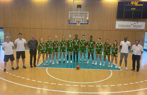 team photo of furdenheim basketball team of 11 players in green jerseys with 5 staff members